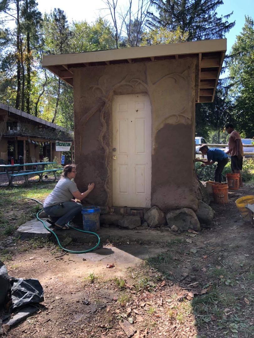 Plastering the Wellhouse with Earthen Plaster