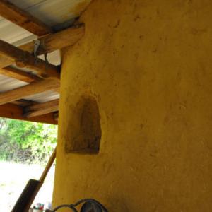 Embeded shelving in earthen cob wall